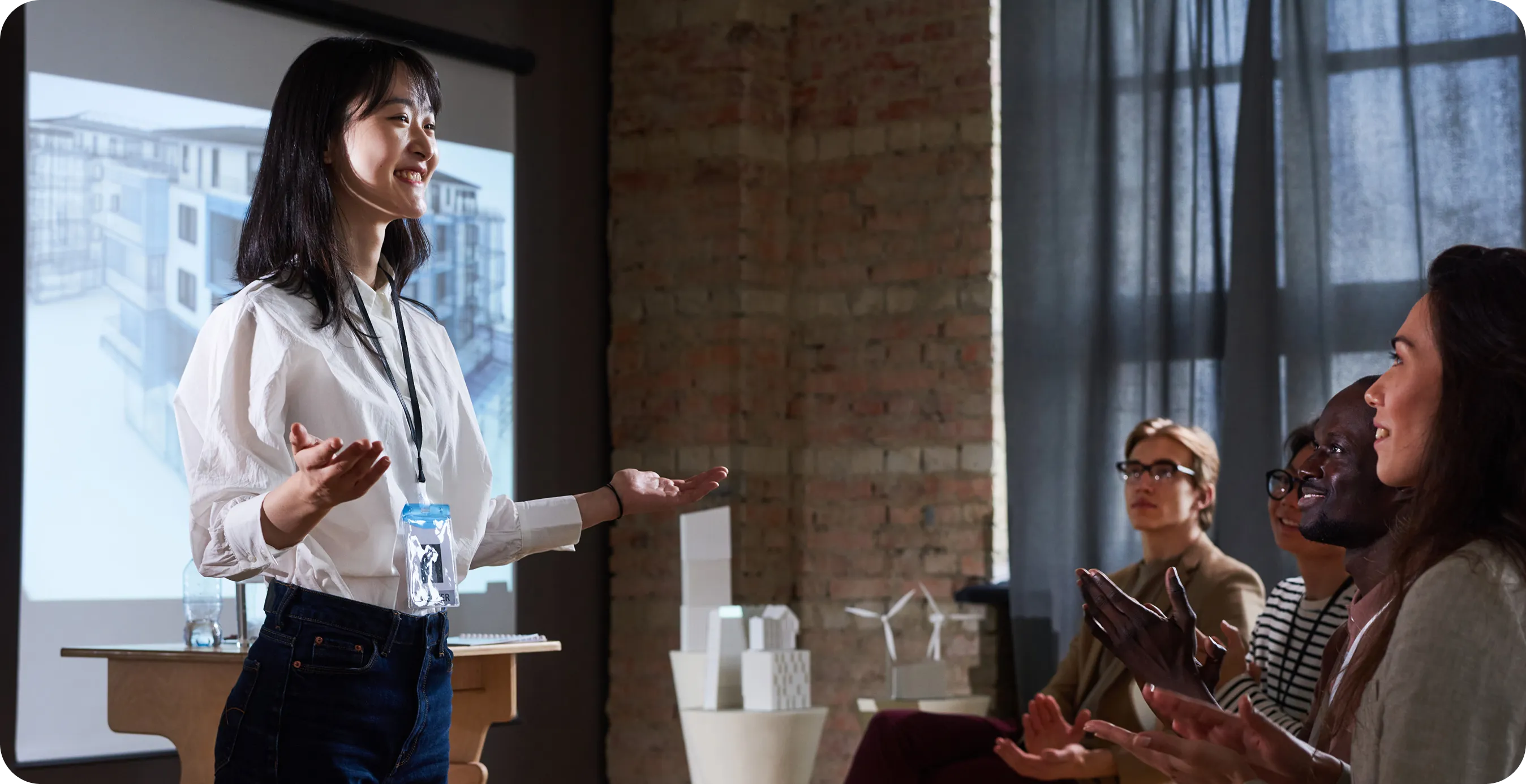 A woman giving a presentation to a group of people.