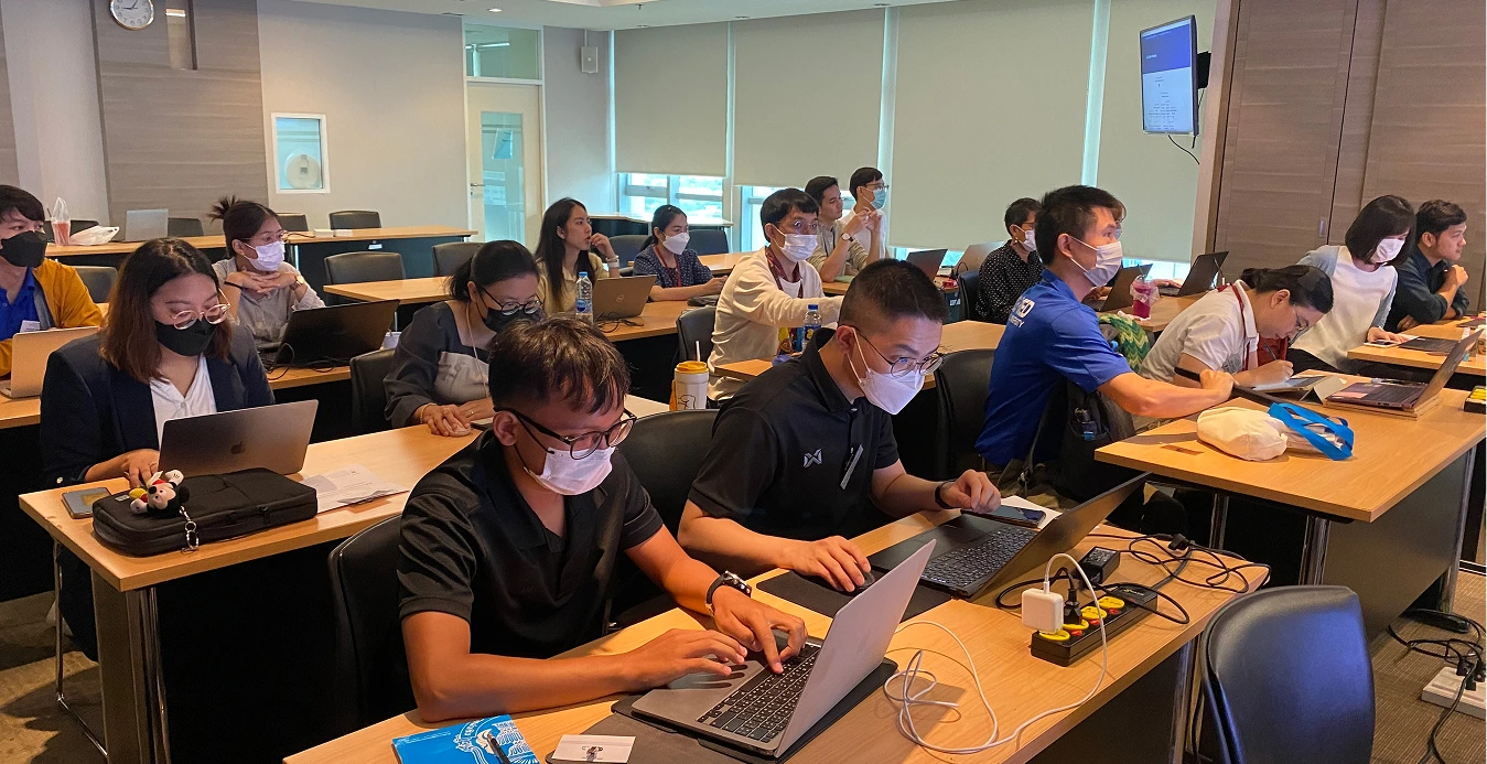 a group of people wearing face masks in a classroom
