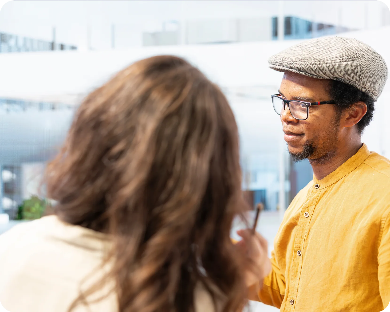 a man in a hat talking to a woman