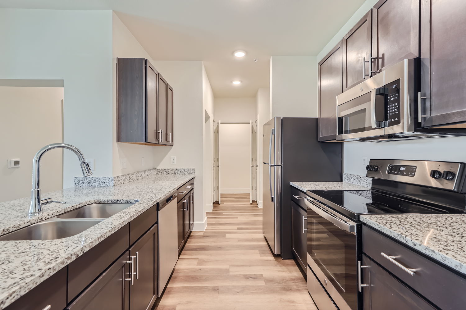 Kitchen with brown cabinets and stainless steel appliances