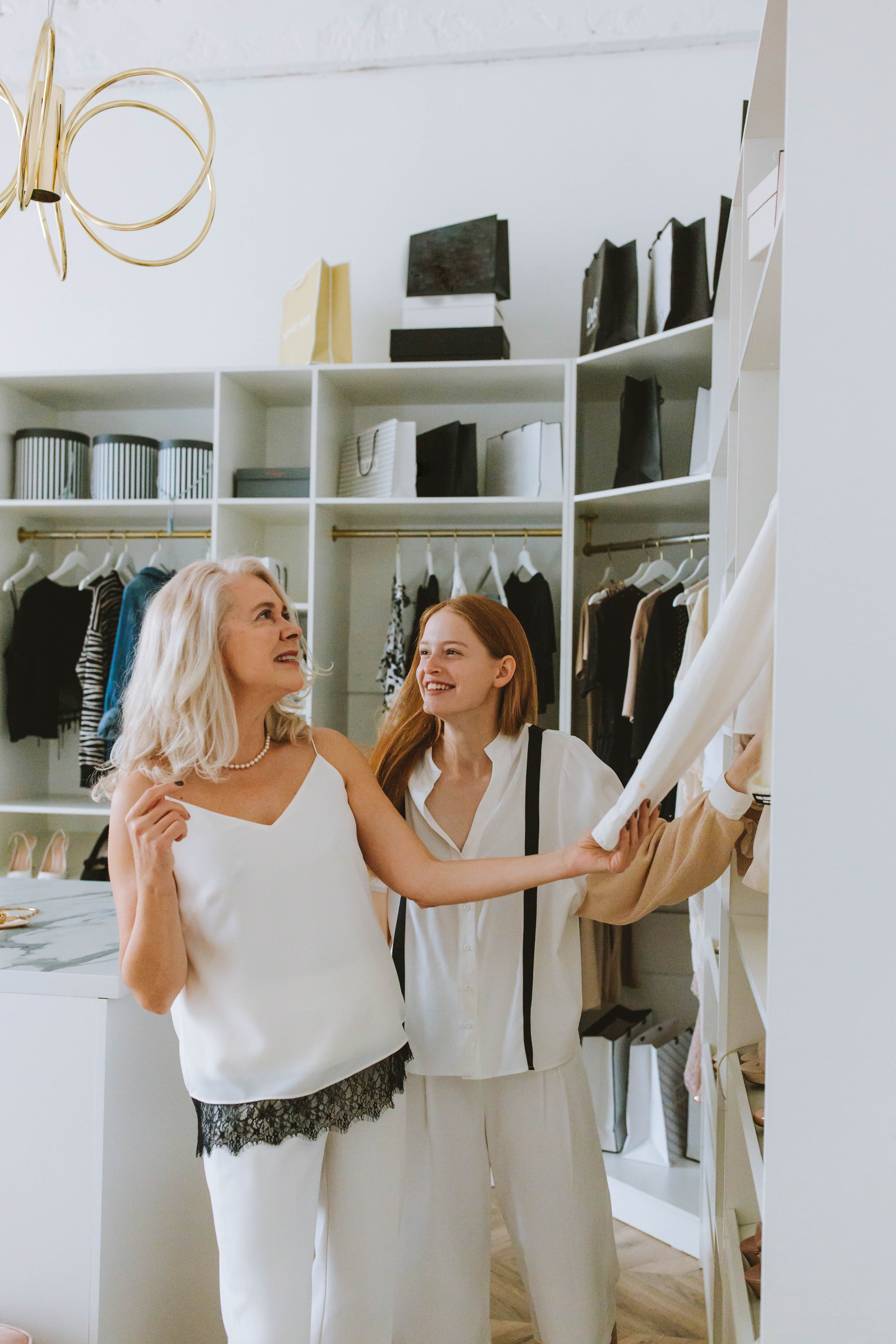 Two women shopping for clothes stock image