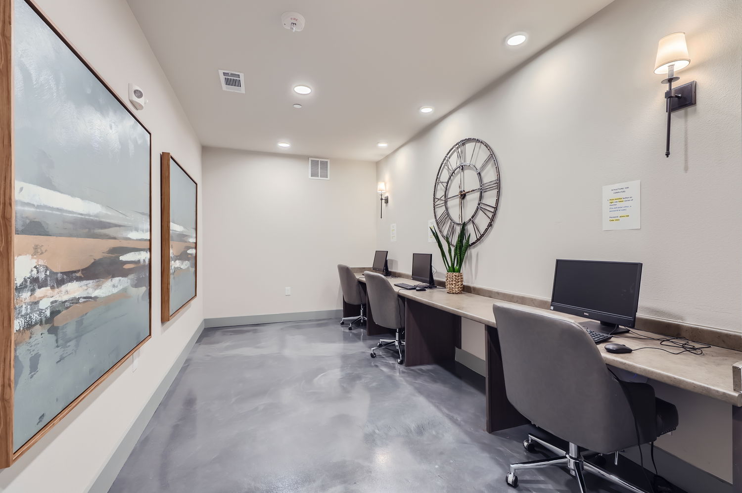 Business center room with computers and desks with chairs