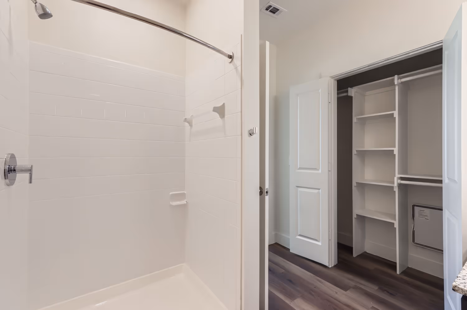 Shower and storage closet with shelving 