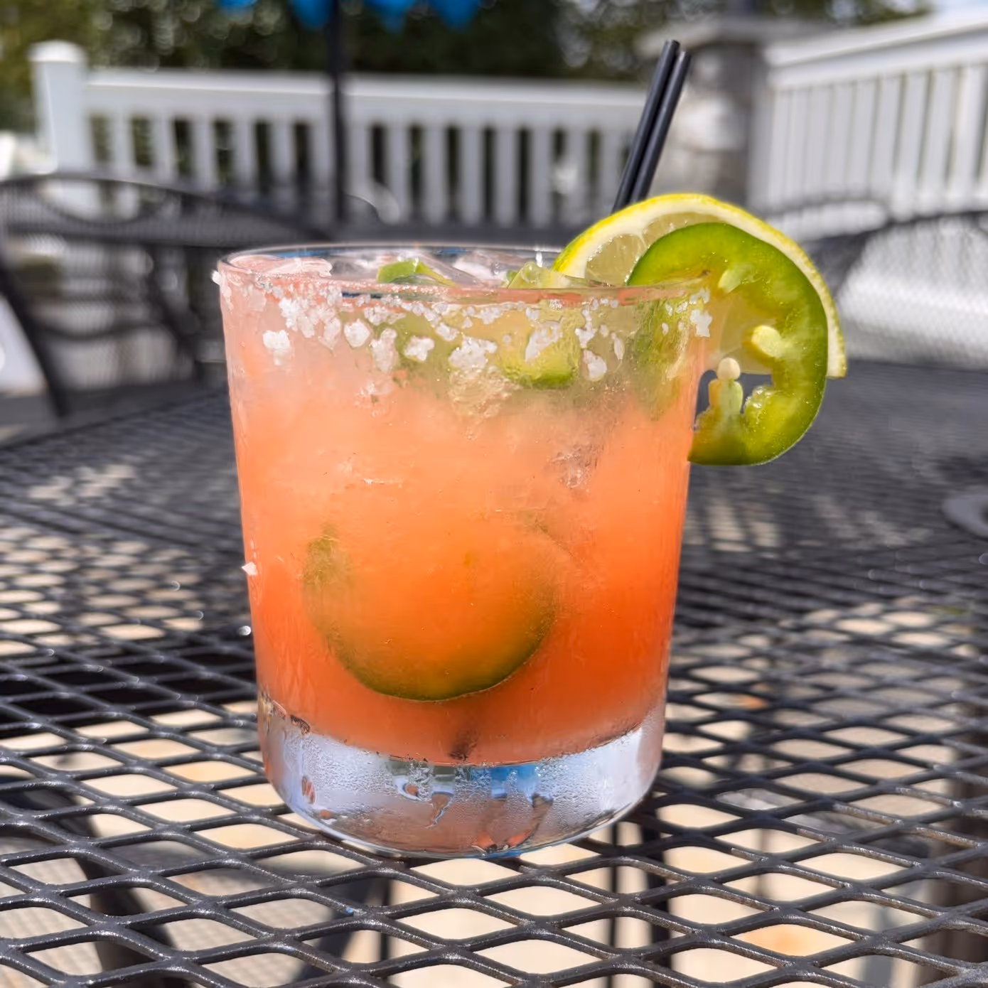 spicy margarita with a slice of lemon and jalapeno