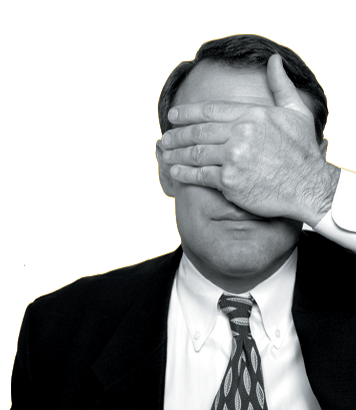 Man in a suit and patterned tie covering his eyes with his hand.