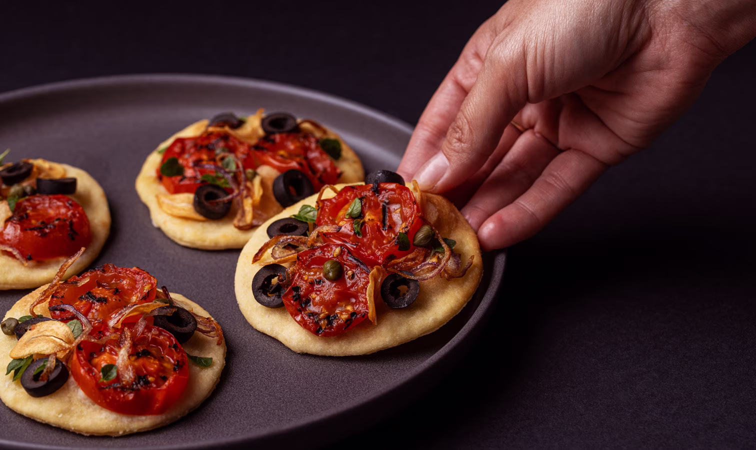 Layered puff pastry dessert with cream and green-striped Midnightplum tomatoes slices on a white plate.