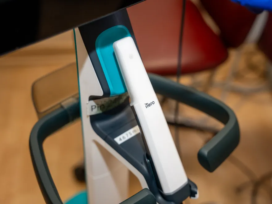 Close-up of an iTero dental scanner device in a clinical setting.