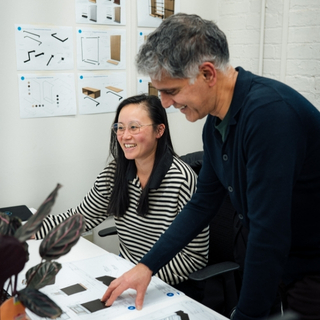 Designer sketching retail layout plans on paper.