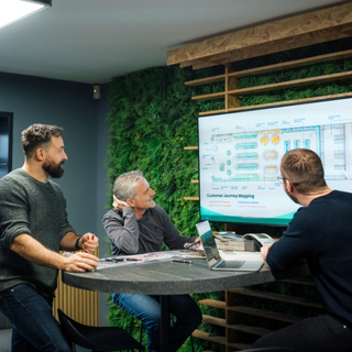 Team reviewing in-store experience strategy around plans.