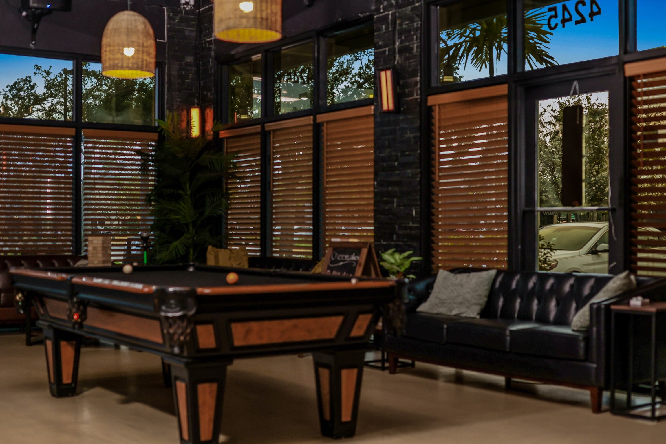 Restaurant or bar interior with custom millwork, pool table, wood accents, and ambient lighting