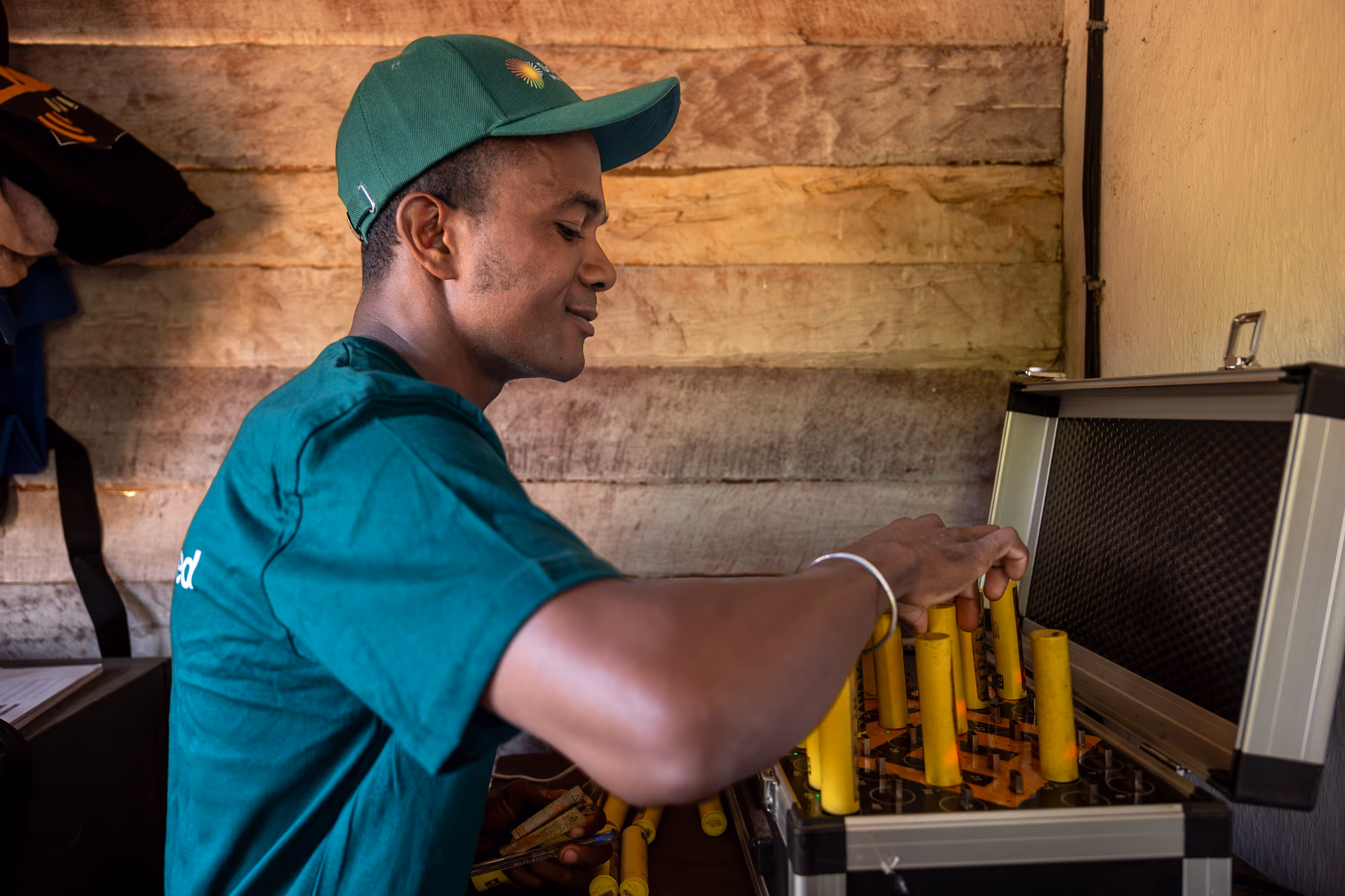 A man operating solar power battery bank.