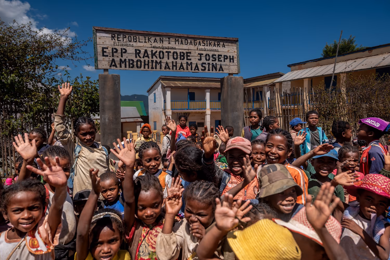 Children in front of a school entrance.