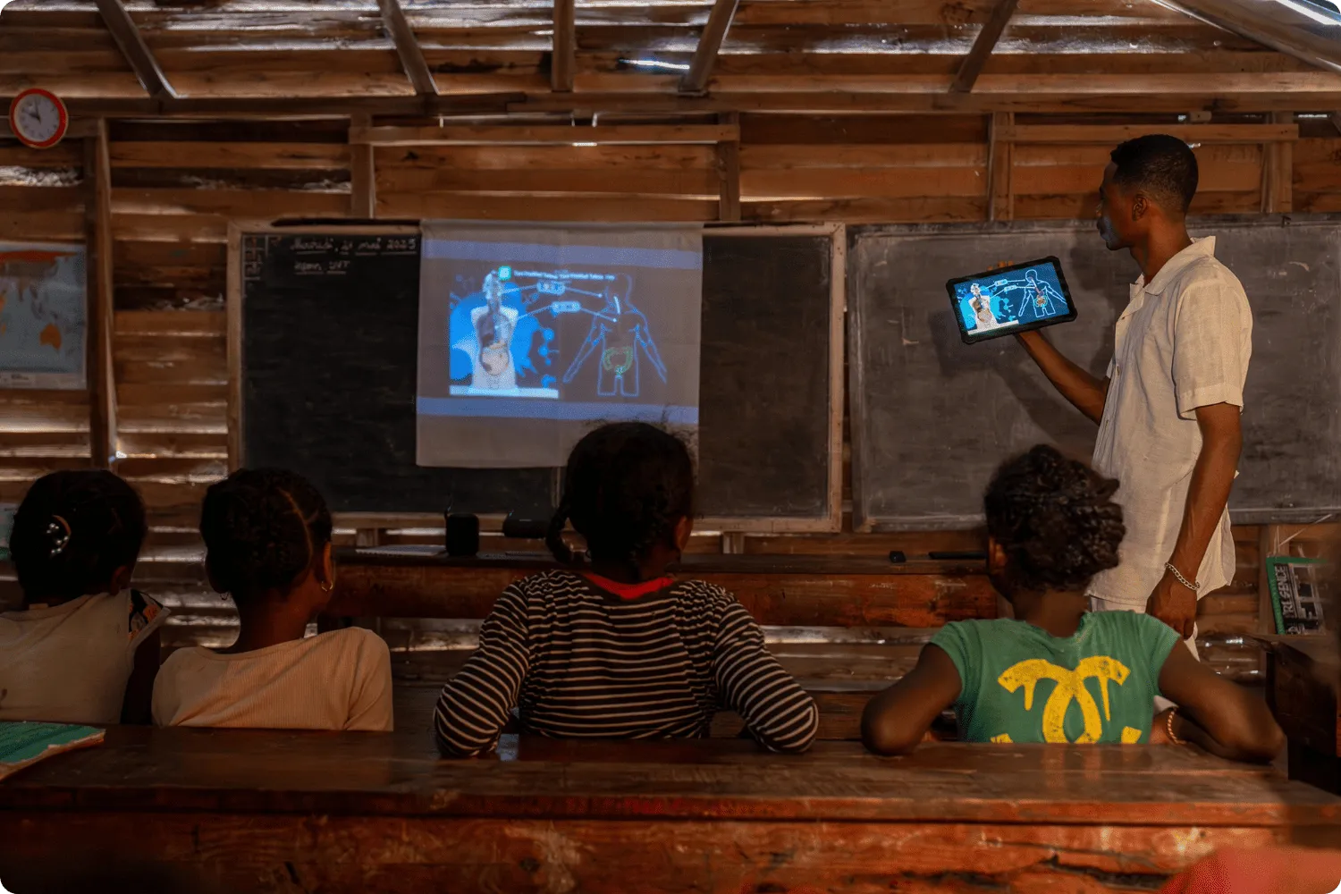 Teacher Espérant delivers a human anatomy lesson using a projection controlled from his tablet
