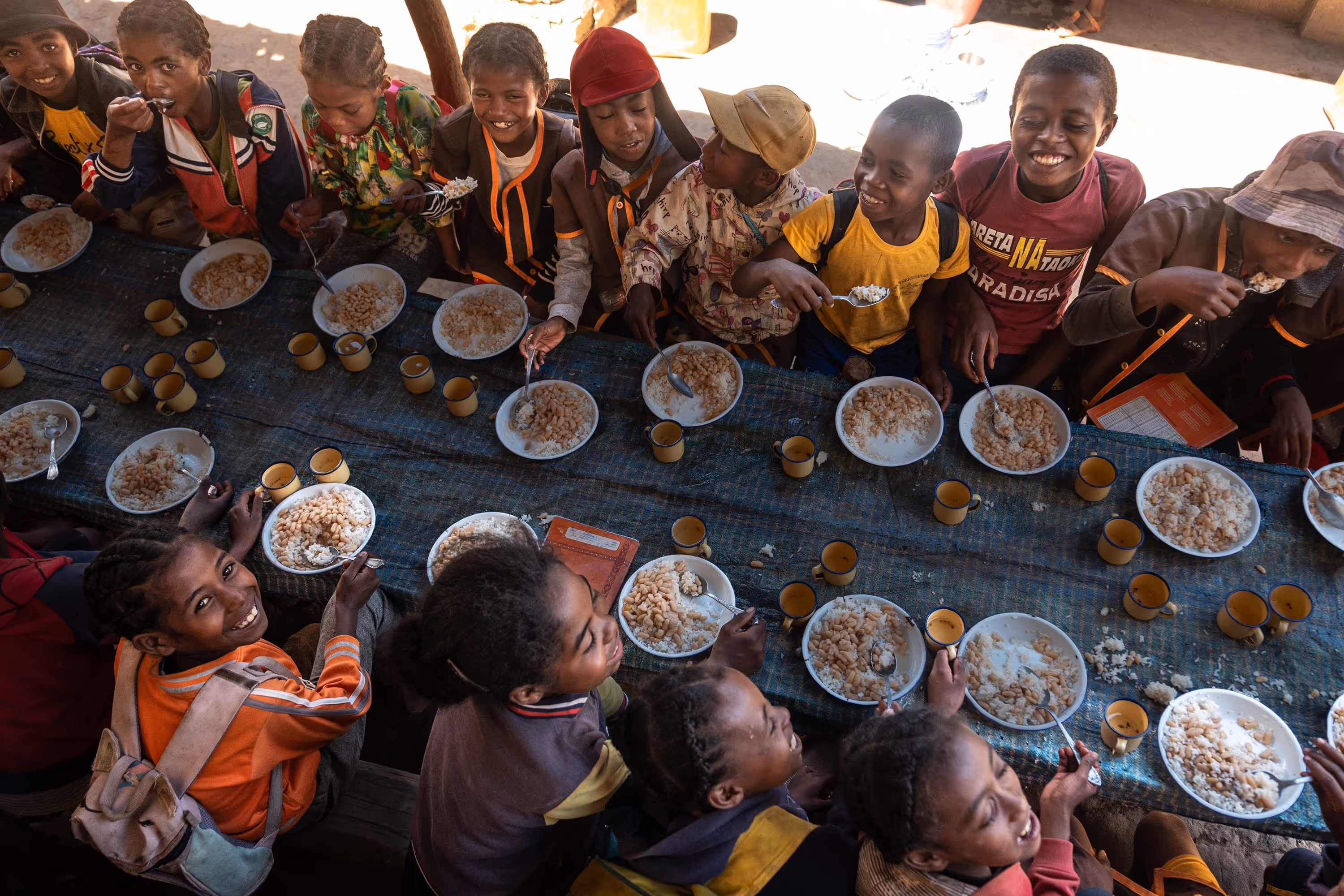 Group of school children sitting at the table and eating