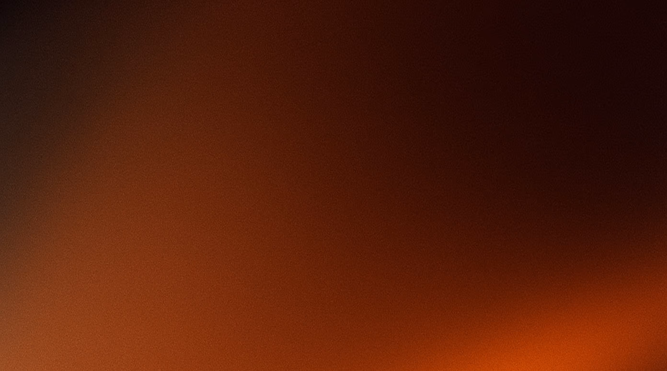Rozostřený gradientní přechod z tmavě hnědé do oranžové barvy.