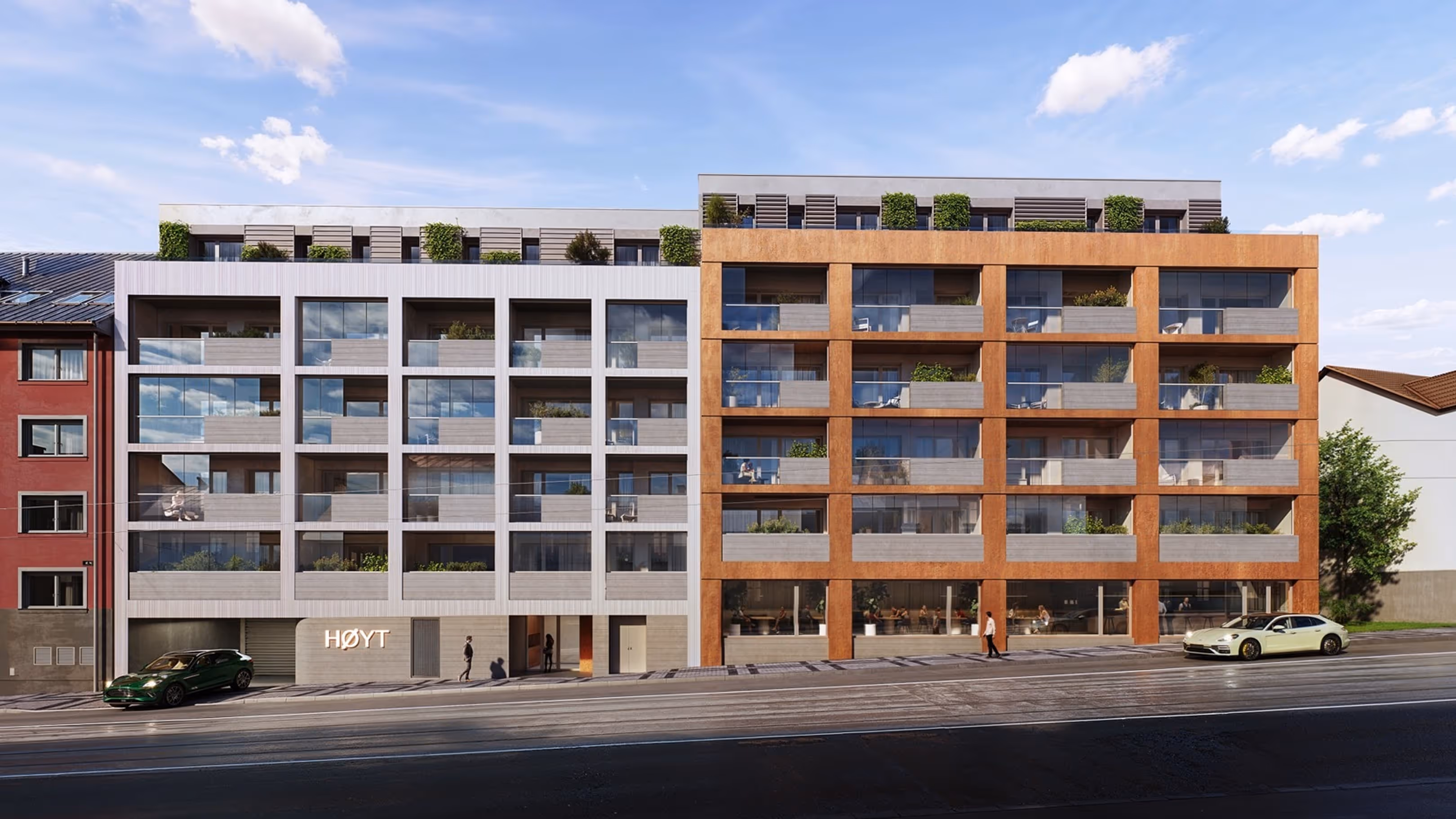 Moderní bytový dům s velkými balkóny a skleněnými zábradlími za slunečného dne.