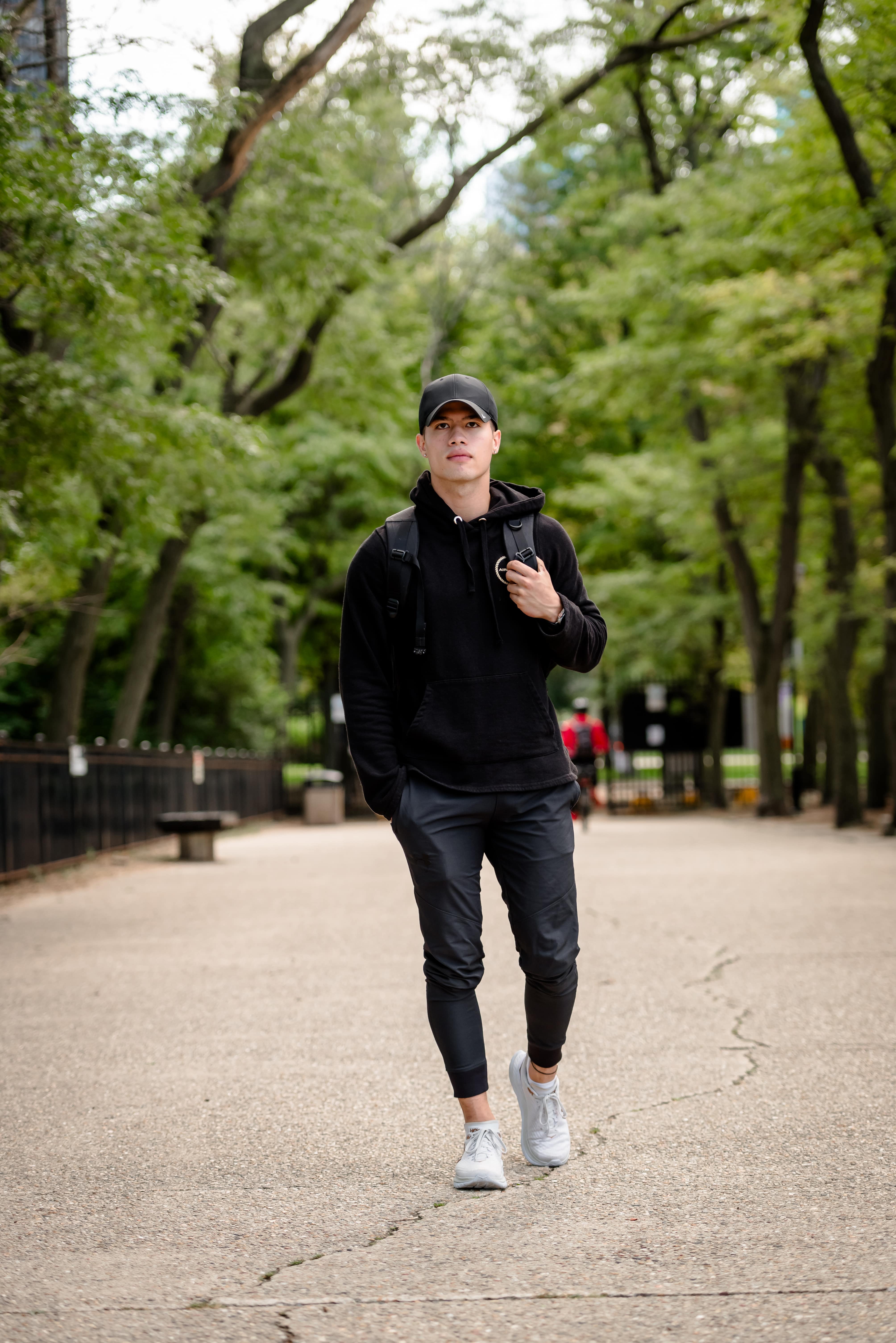 Luke Embers walking seriously outside with his hand in pocket.