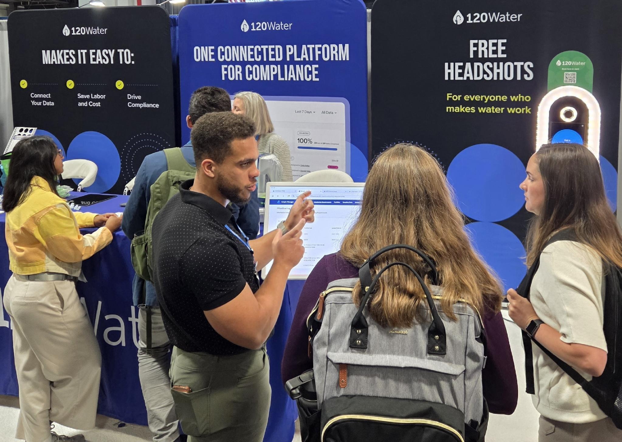 120Water team members talking with attendees at ACE26