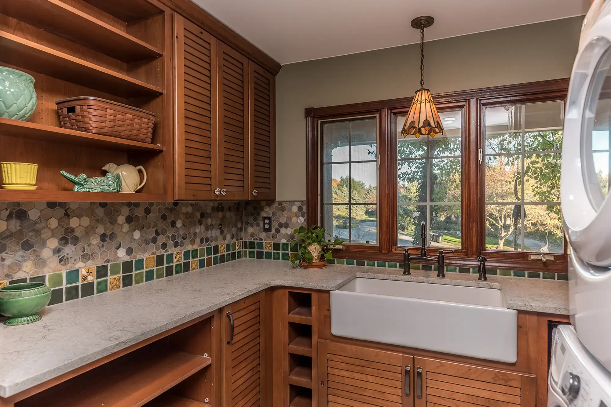 Wood-paneled kitchen with farmhouse sink