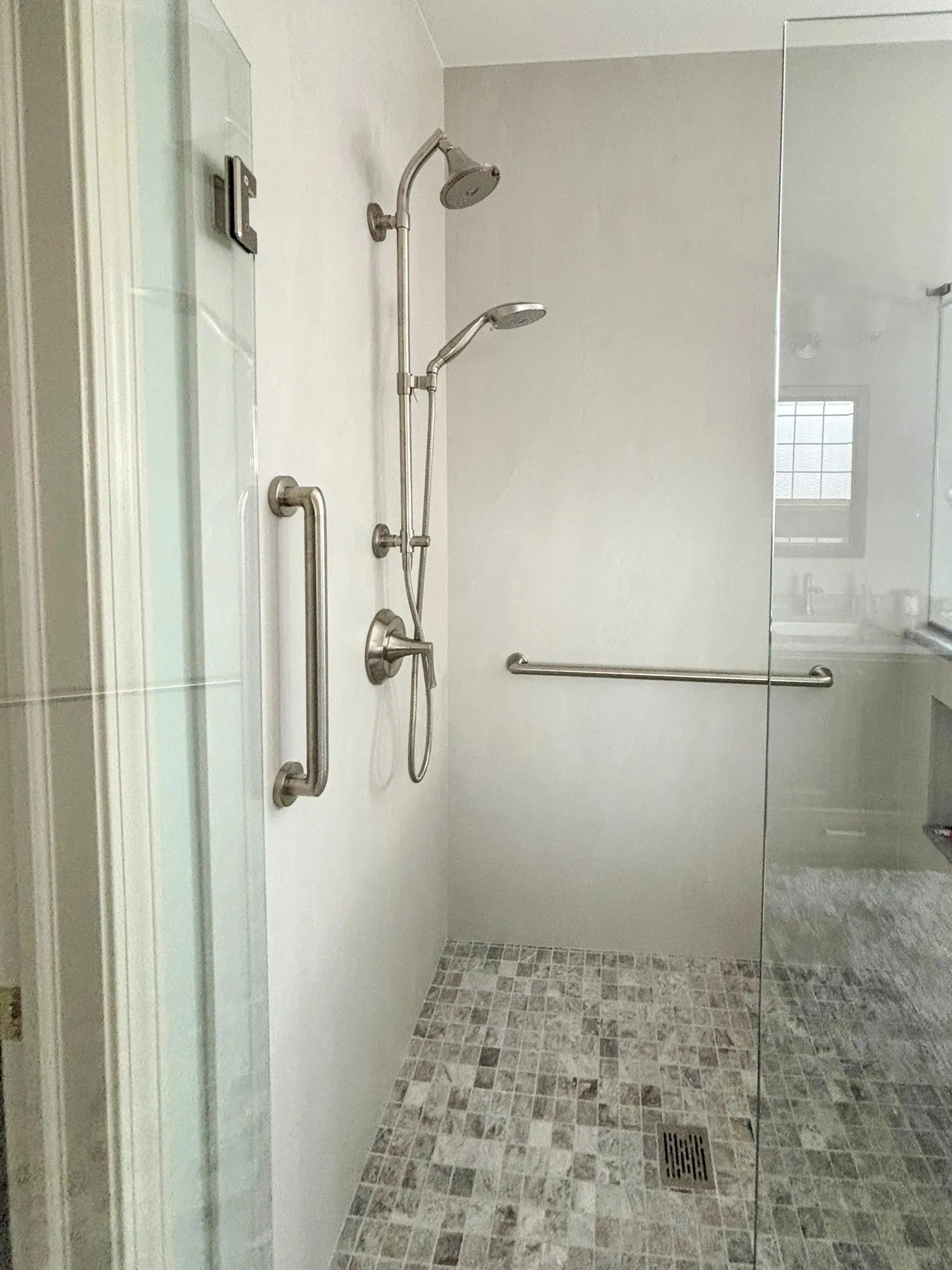 Modern walk-in shower with dual showerheads