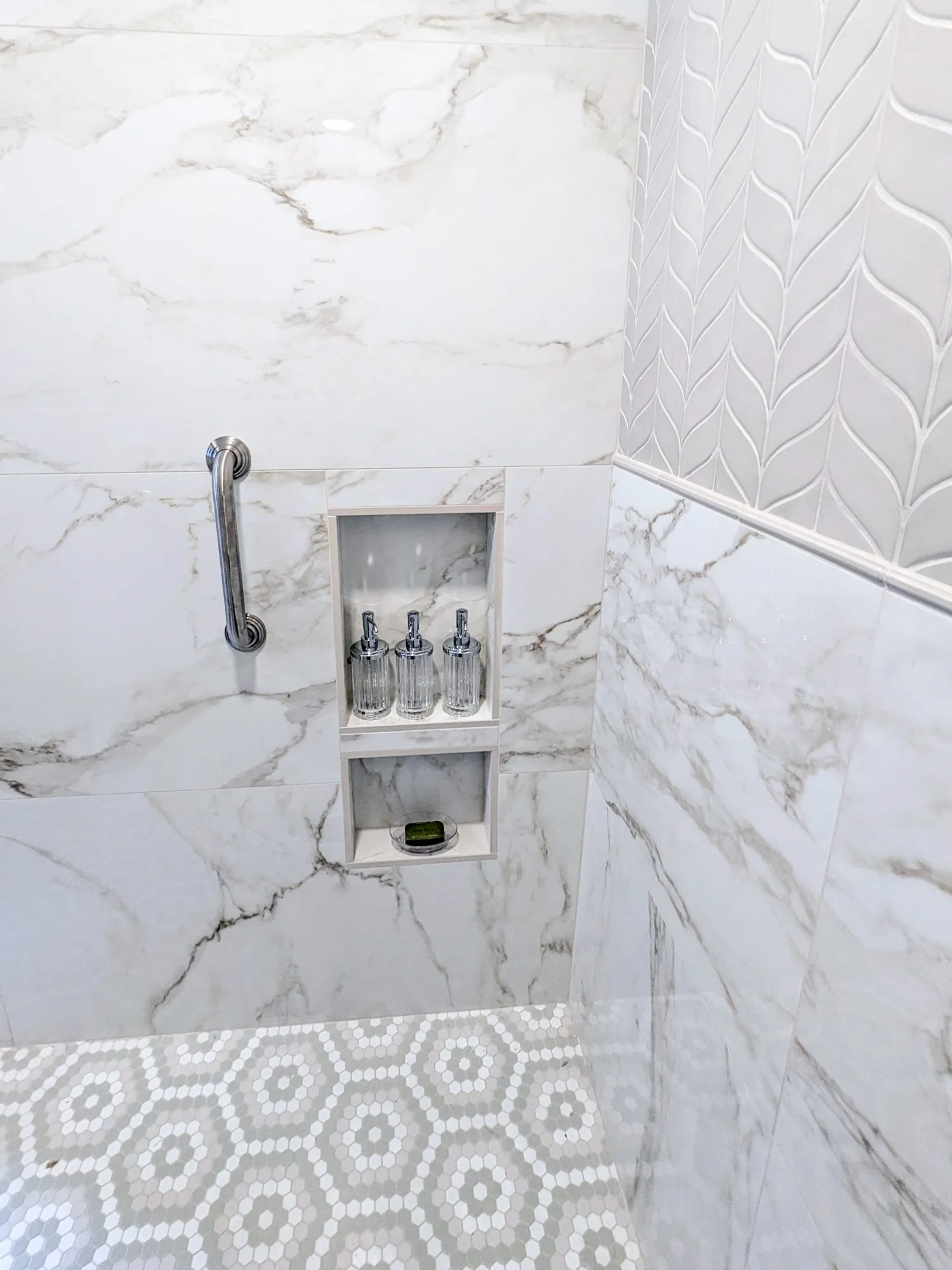 Marble-tiled shower with built-in shelf