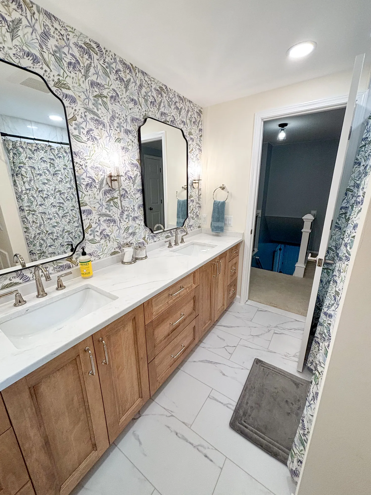 Modern bathroom with floral wallpaper and wood vanity in a contemporary style
