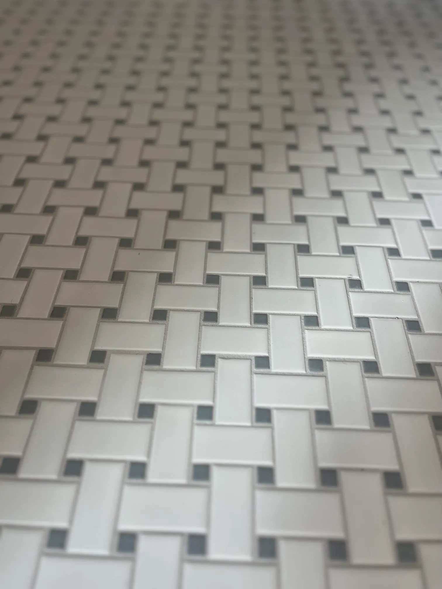 Stylish woven tile pattern in a modern kitchen, featuring light gray and white tones.