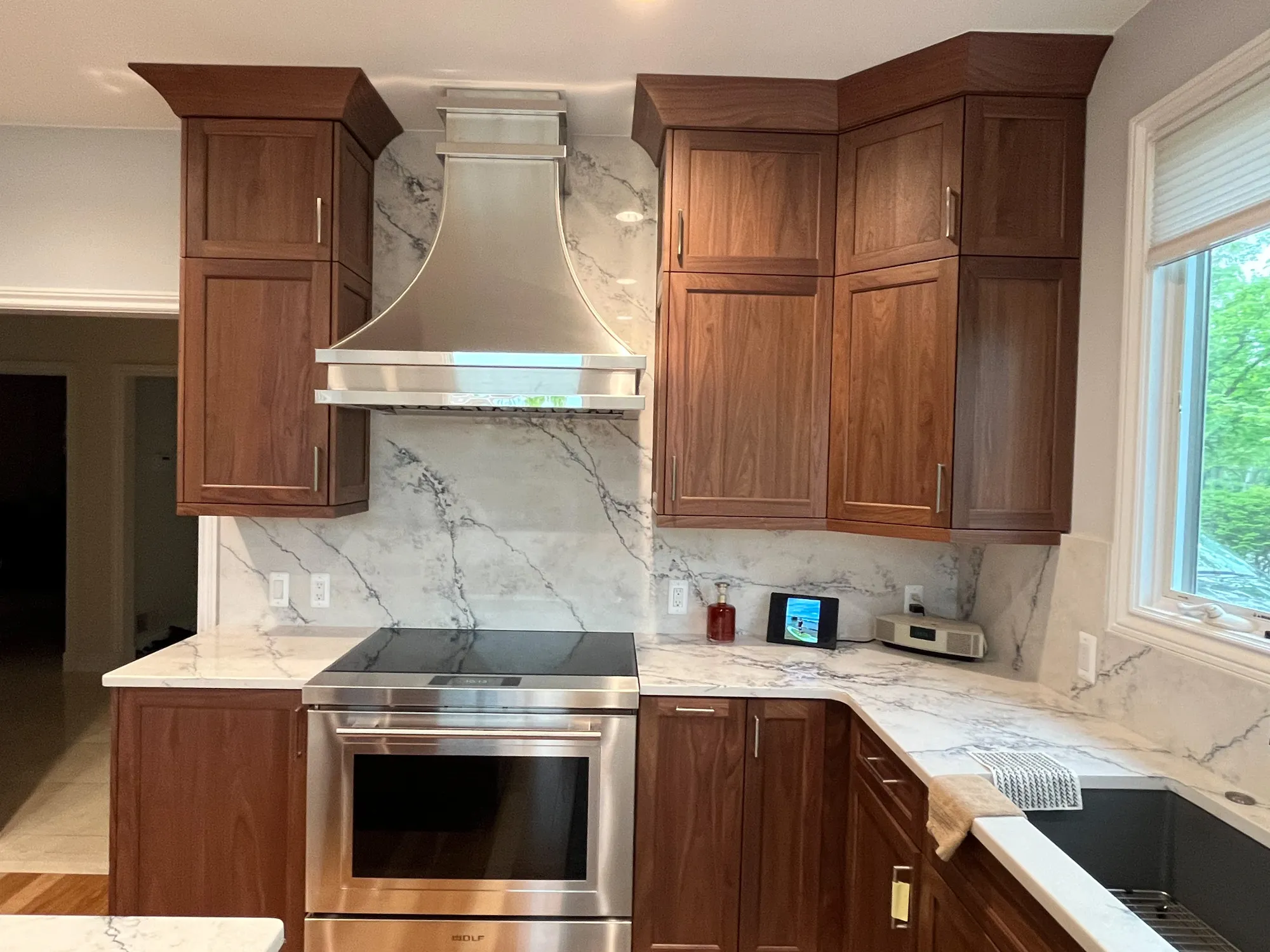 modern kitchen with dark wood cabinets and marble countertops in plymouth, michigan