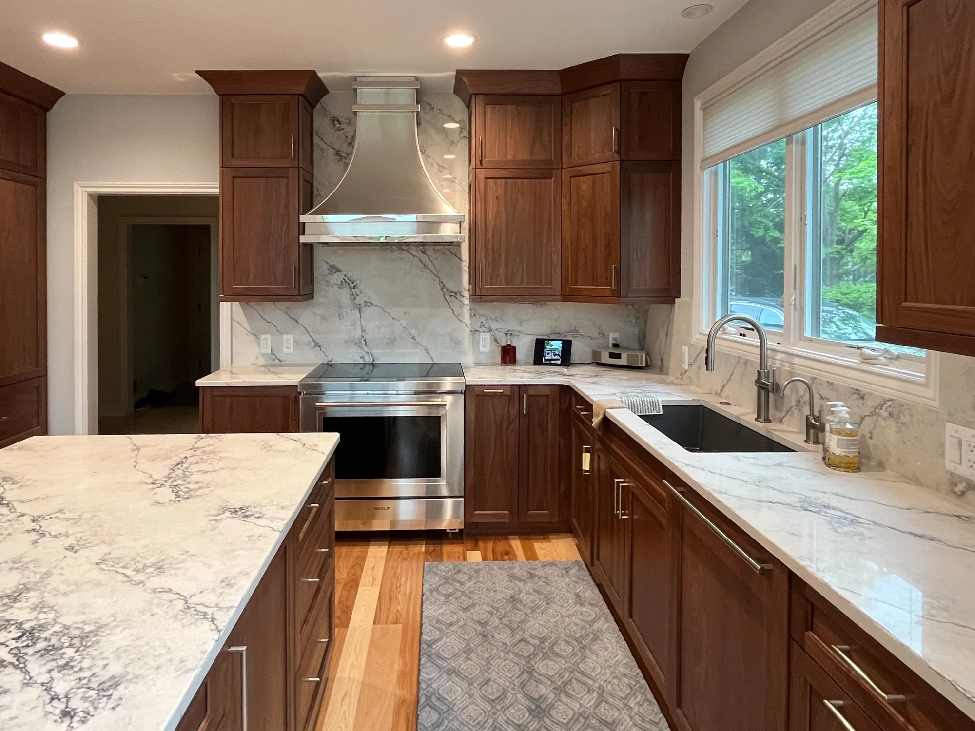 Modern kitchen in plymouth, michigan featuring shaker cabinets and marble countertops