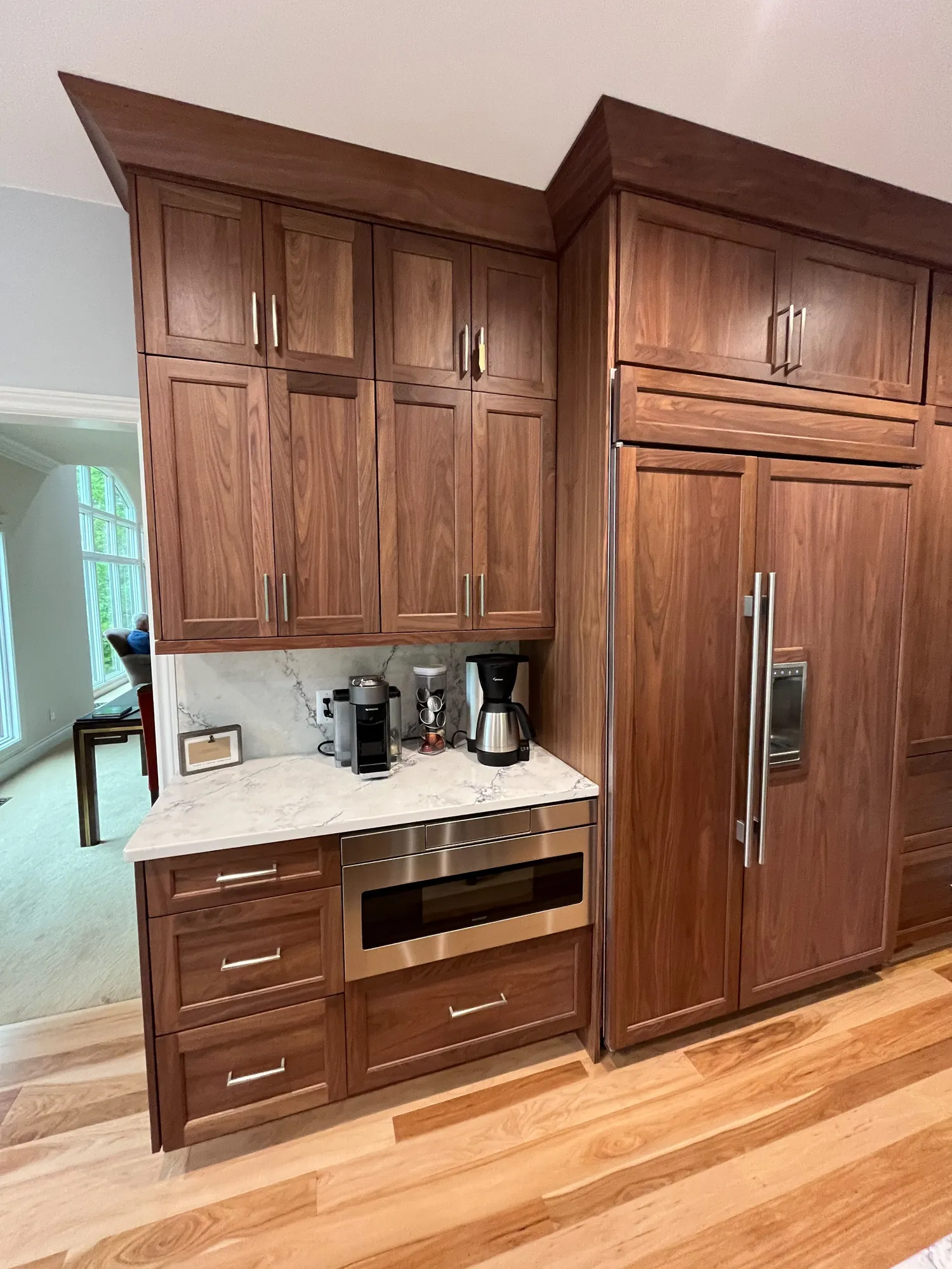 Luxury kitchen remodel featuring dark shaker cabinets, marble countertop, and stainless steel appliances in plymouth.
