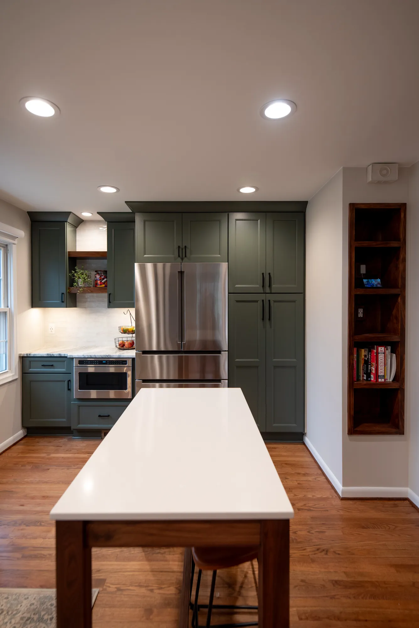Contemporary kitchen featuring gray cabinets, stainless steel appliances, and a white countertop.