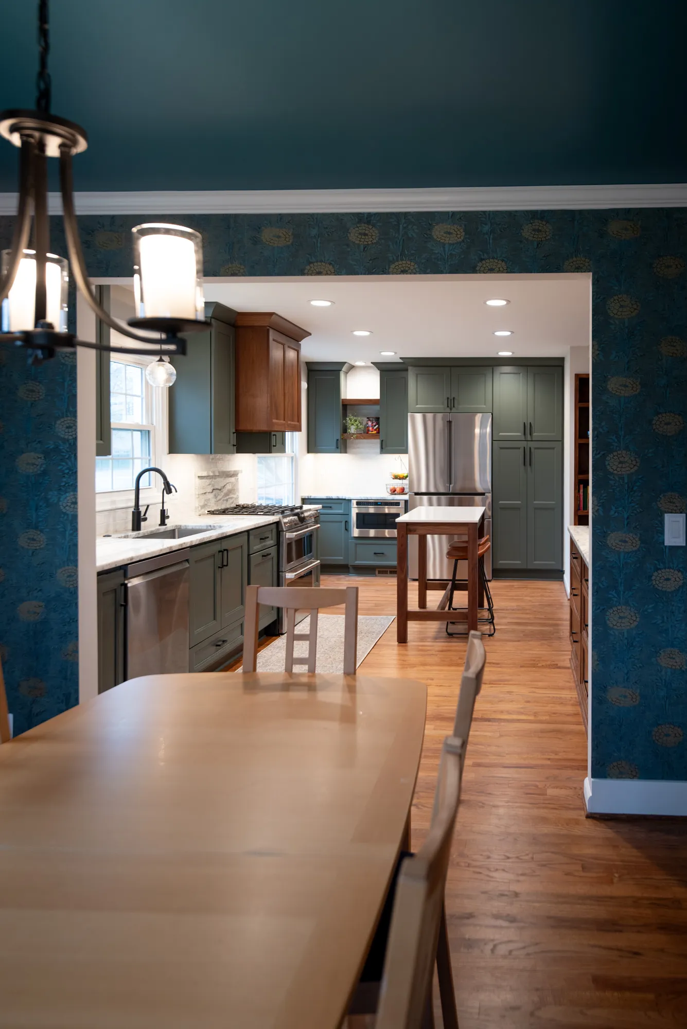 Modern kitchen featuring blue cabinetry, wood accents, and a stylish design in an inviting space