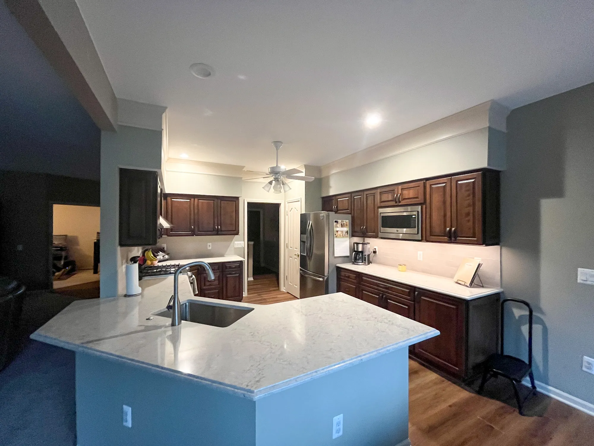 Modern kitchen remodel featuring dark wood cabinets and a marble countertop in a comfortable Plymouth home.