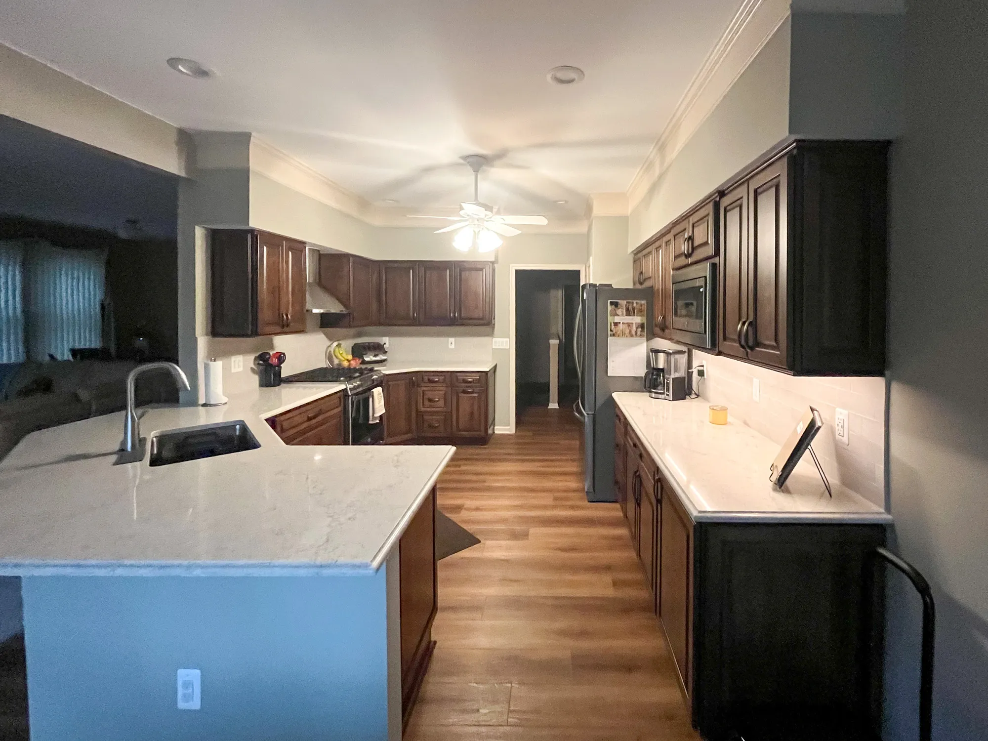 Modern kitchen remodel with dark wood cabinets and quartz countertops in plymouth, michigan
