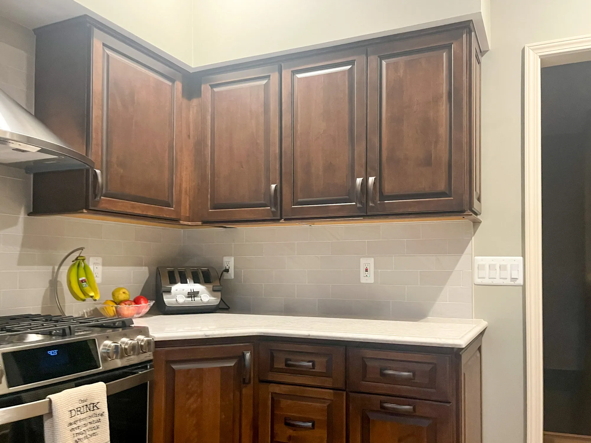 Modern kitchen in plymouth, michigan with dark wood cabinetry and subway tile backsplash.