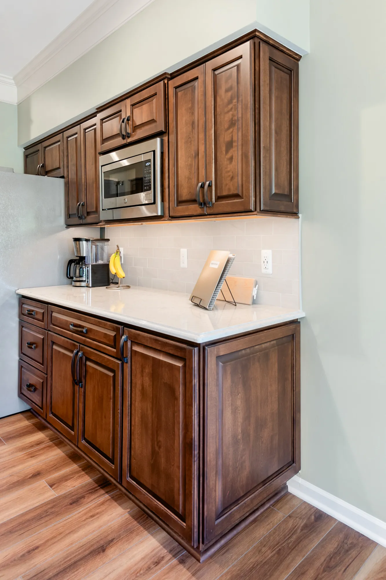 modern kitchen renovation featuring dark wood cabinets and gray countertops in plymouth, michigan