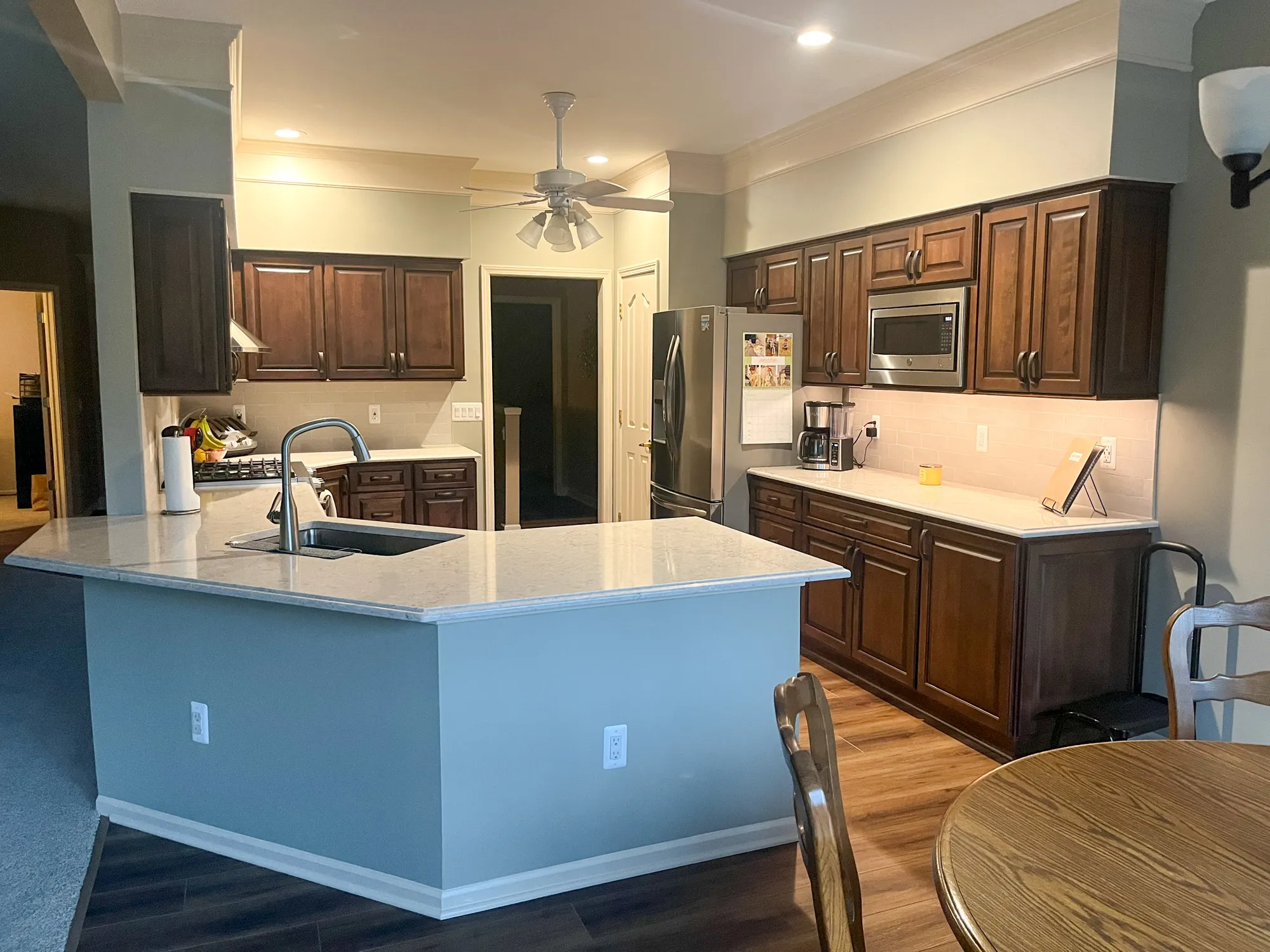 Stylish kitchen remodel with dark wood cabinets, granite countertops, and modern appliances in plymouth, michigan.