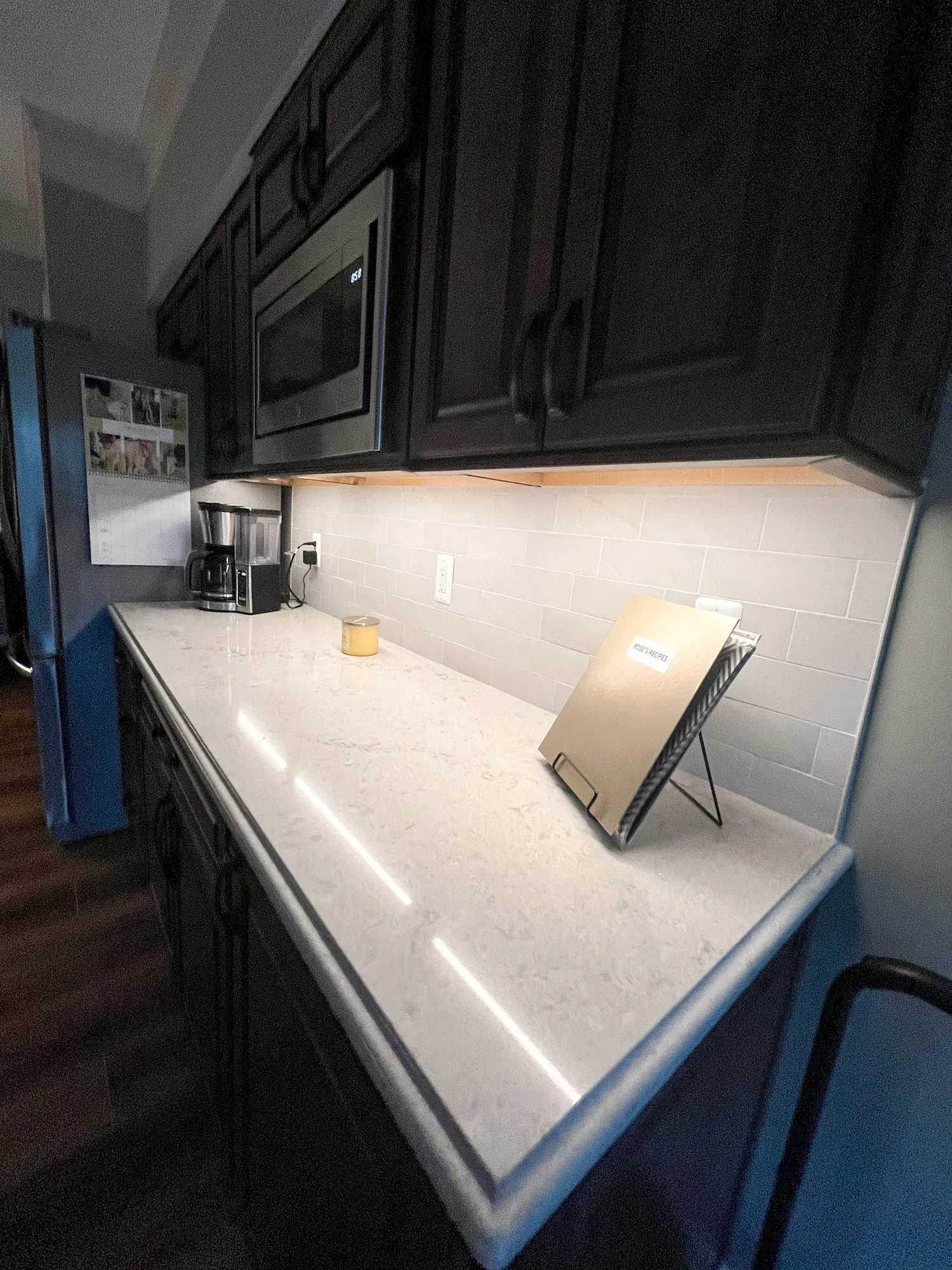 Modern kitchen with under-cabinet lighting and subway tiles in plymouth, michigan.