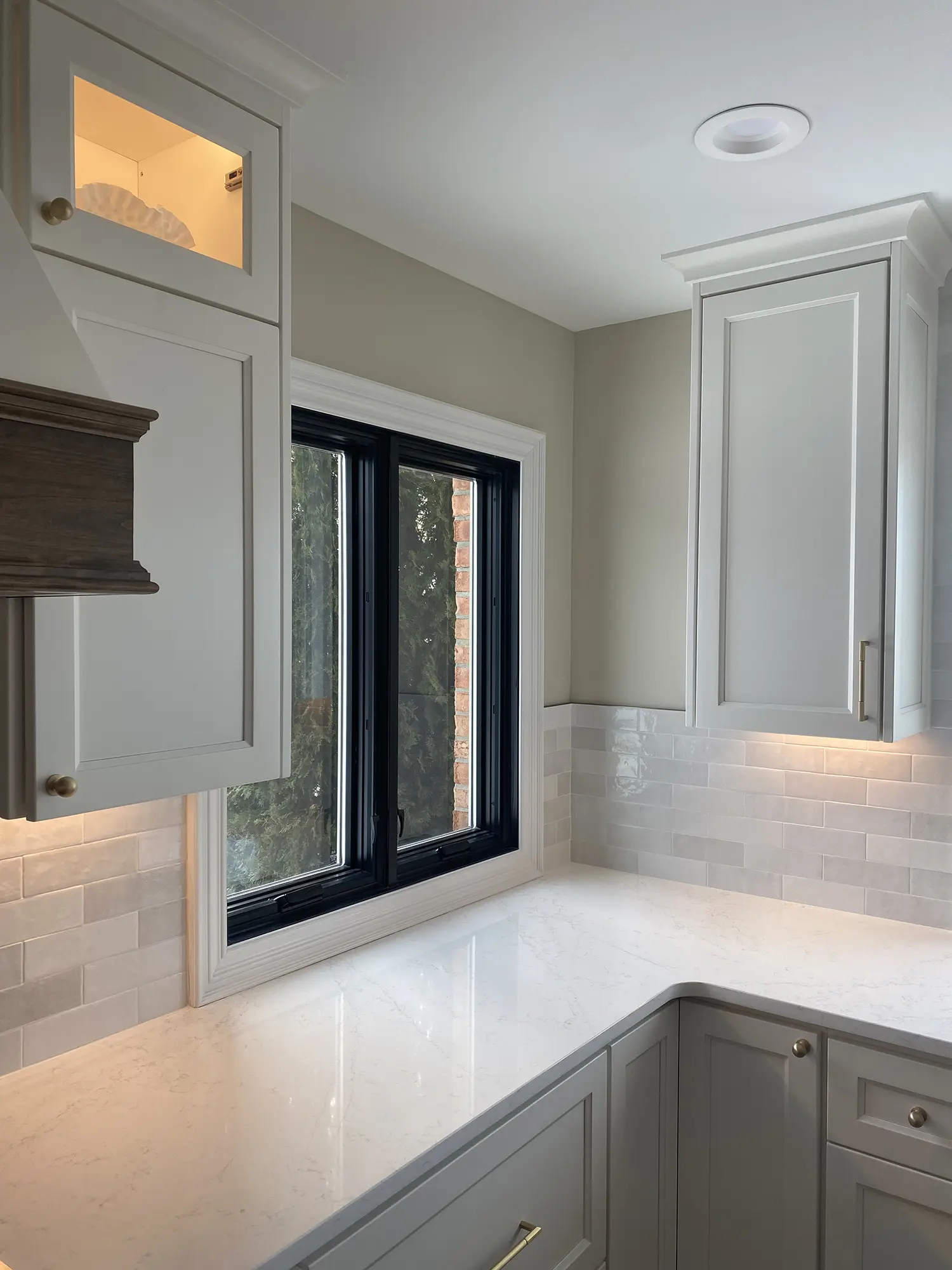 Kitchen corner with marble countertop, and black-framed window