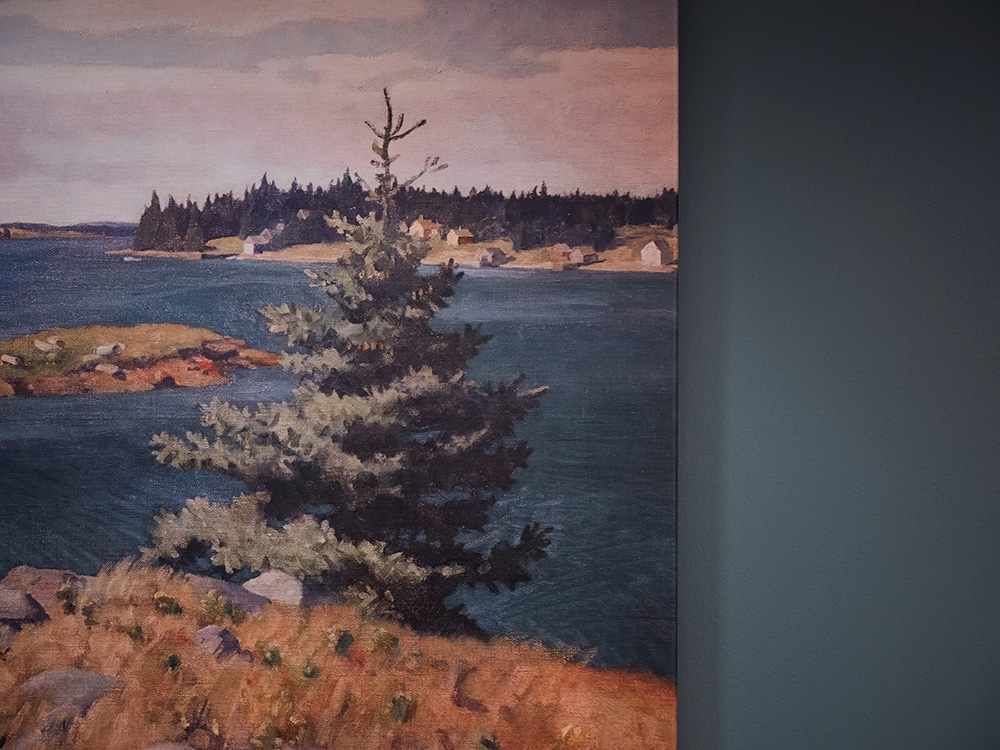 Painting of a coastal landscape featuring a pine tree in the foreground, a blue body of water, rocky shores, and a forested area with small houses in the distance.