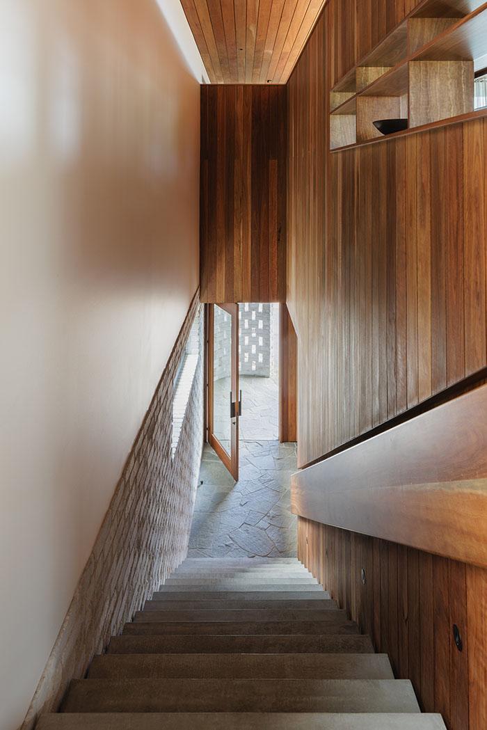 looking down stairs towards the entry showing void above stairs with wooden timber work