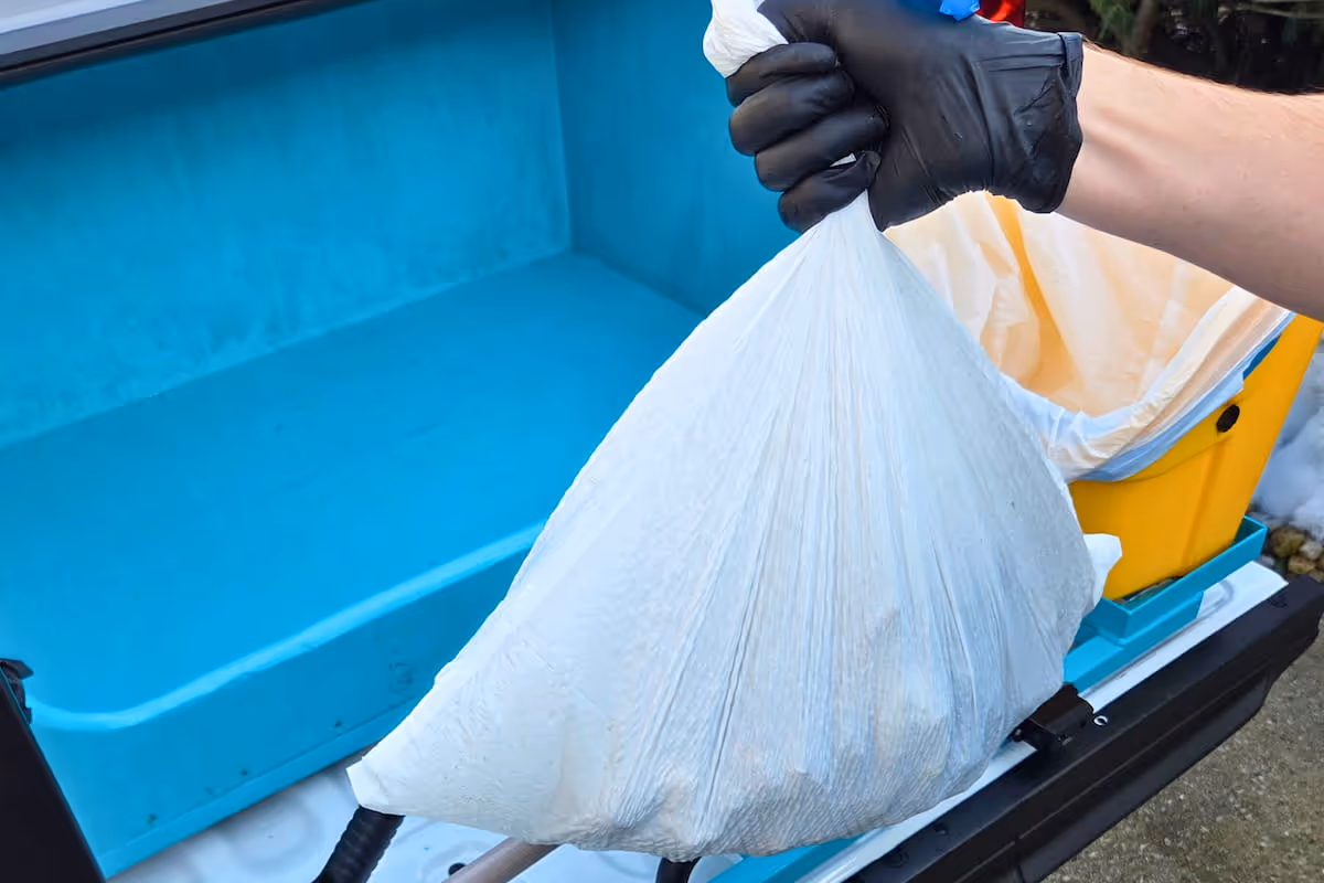 Doo Away team member disposing of bag of waste
