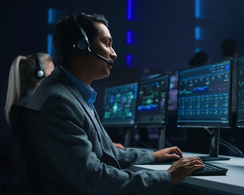 a professional speaking with someone on the phone in a high-tech office setting