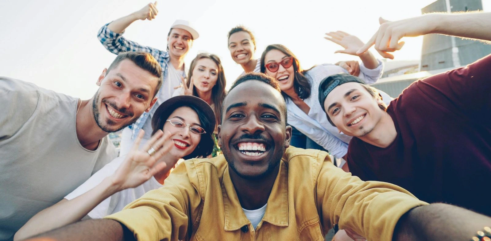 Diverse group of young adults pose for a team photo.