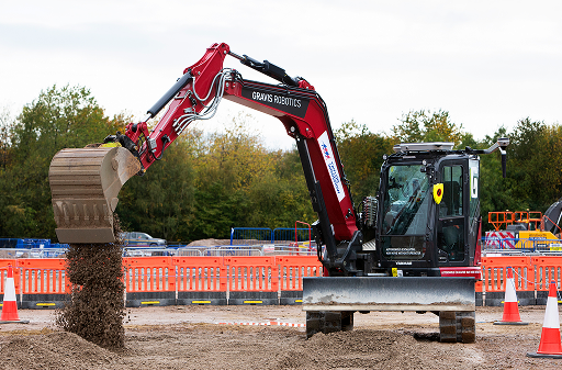 Gravis Robotics autonomous excavator loading gravel at a construction site