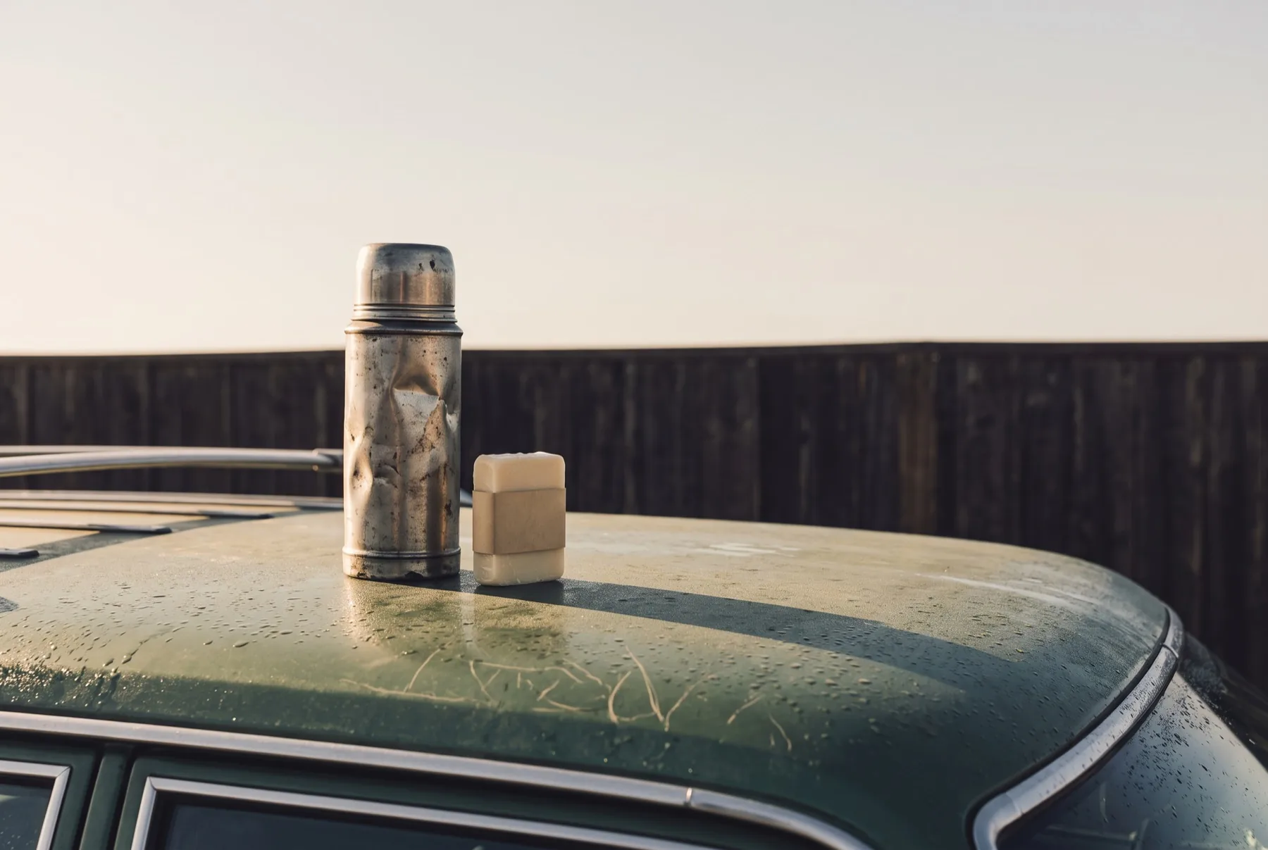 A thermos and a block of wax on a car roof