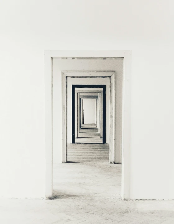 Long corridor with repeated white door frames creating a deep perspective effect.