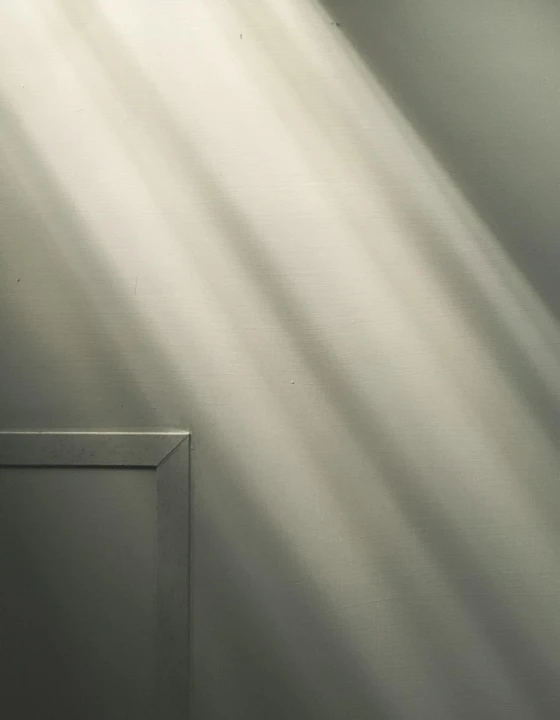 Soft sunlight streaming through a window, casting vertical rays onto the floor.