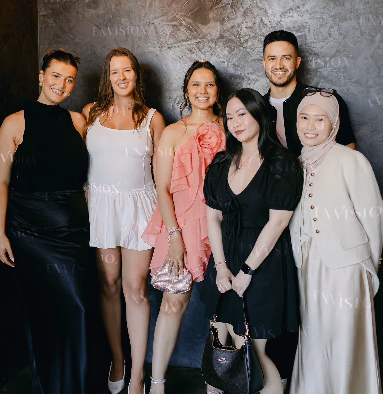 Man and women posing in front of a camera.