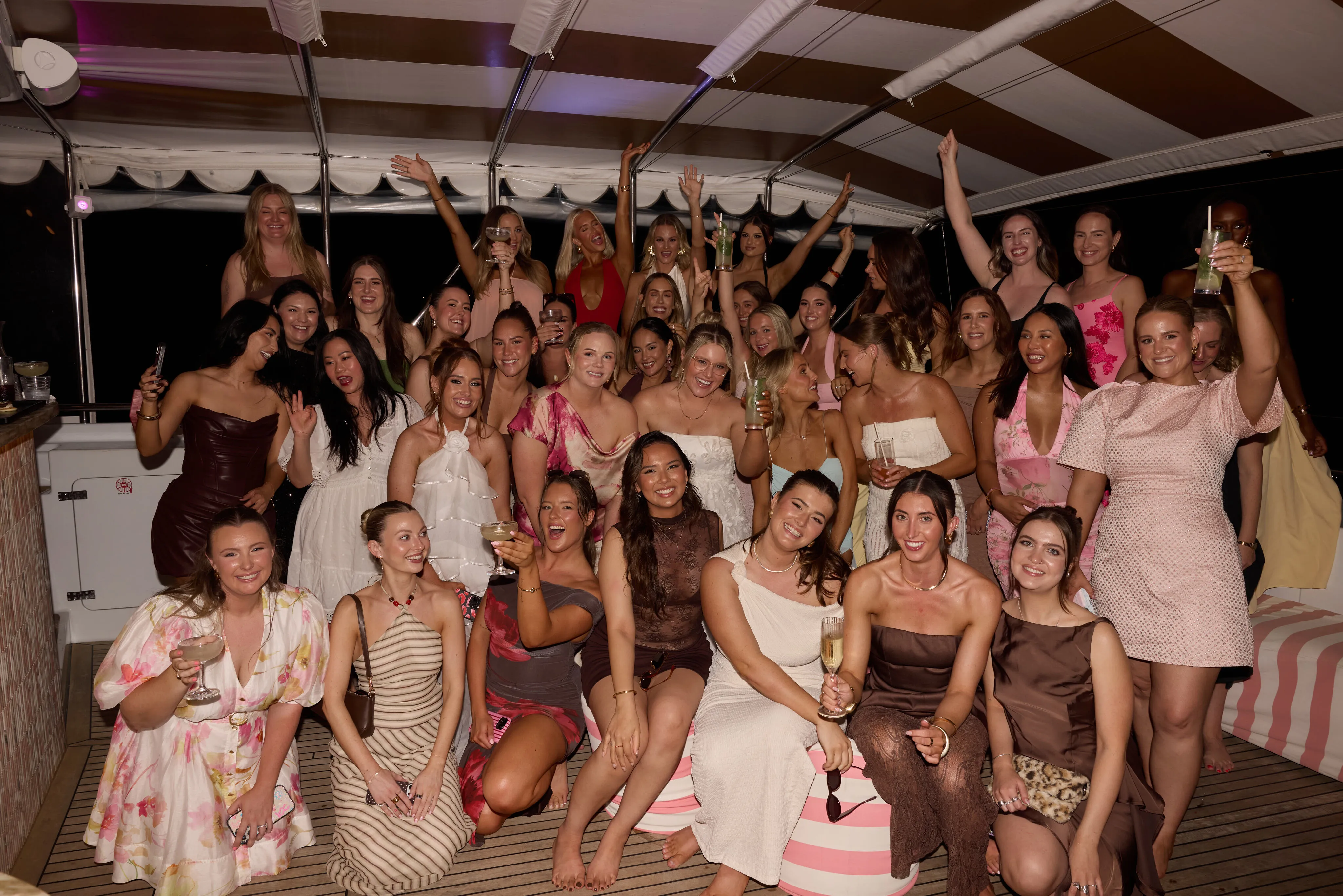 A group of people smiling and celebrating.